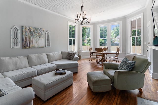 living room with ornamental molding, hardwood / wood-style floors, and a notable chandelier