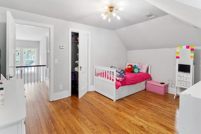 bedroom featuring vaulted ceiling and light hardwood / wood-style flooring