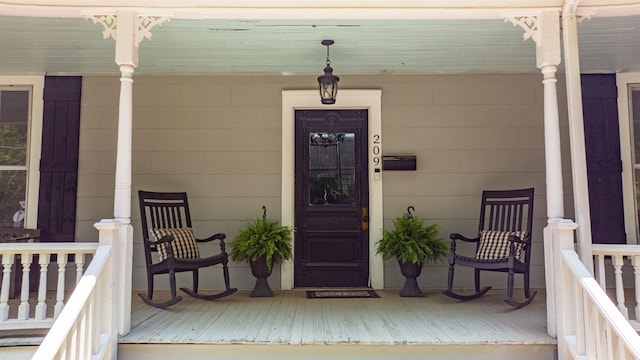 view of exterior entry with a porch