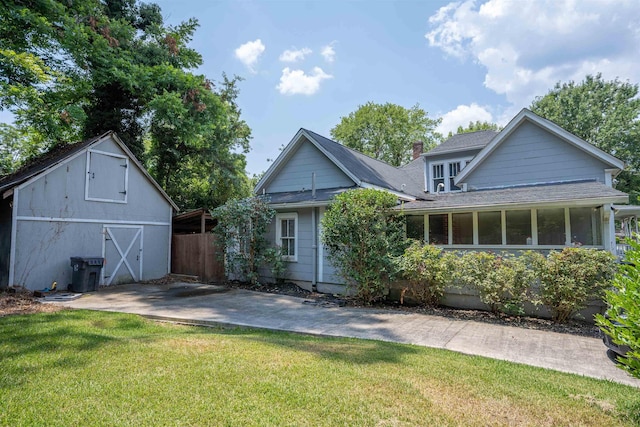 back of property featuring a lawn