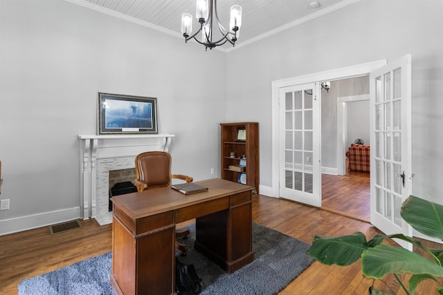 office area featuring crown molding, a brick fireplace, hardwood / wood-style floors, and french doors