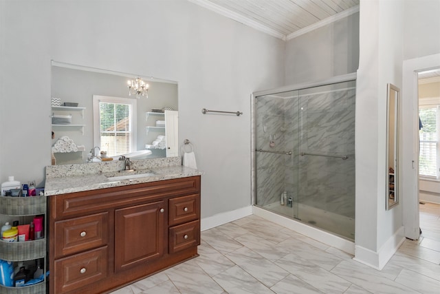 bathroom with an inviting chandelier, ornamental molding, a shower with shower door, and vanity