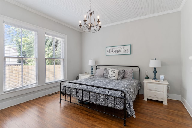 bedroom with a notable chandelier, ornamental molding, and dark hardwood / wood-style floors