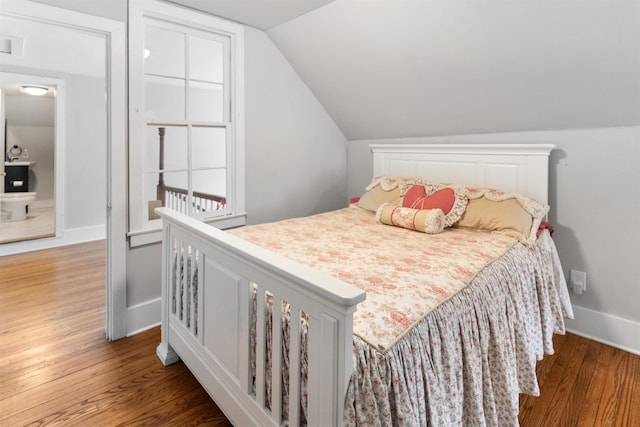 bedroom with hardwood / wood-style flooring and vaulted ceiling