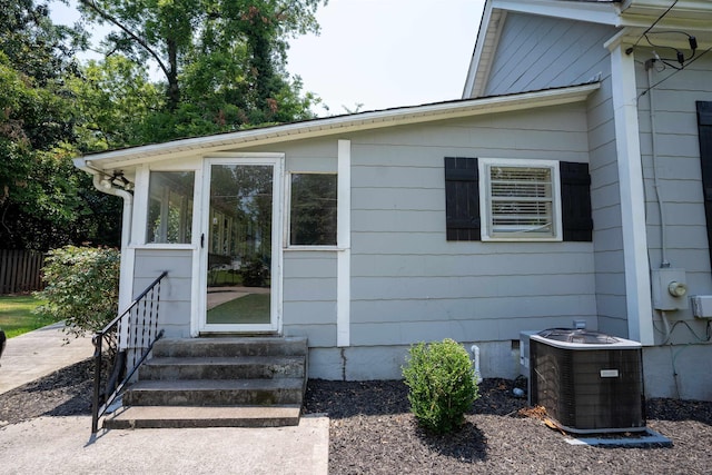 property entrance featuring central AC unit