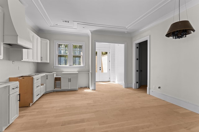 1111 Swift Crk, Greensboro, GA 30642 - kitchen with premium range hood, ornamental molding, white cabinets, light wood-style flooring, and pendant lighting