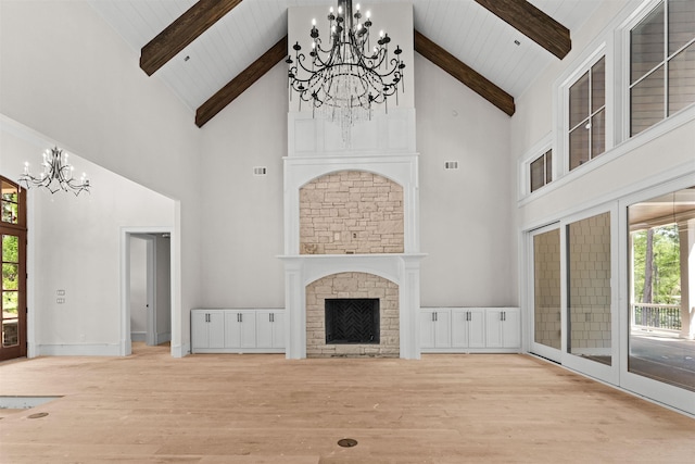 1111 Swift Crk, Greensboro, GA 30642 - unfurnished living room featuring a chandelier, high vaulted ceiling, wood finished floors, wood ceiling with exposed beams, and a stone fireplace
