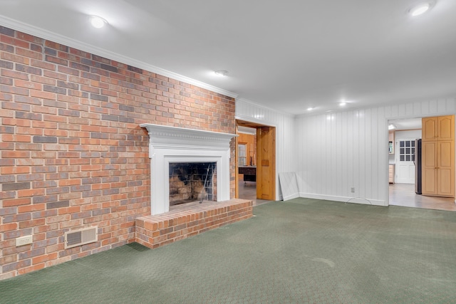 unfurnished living room featuring carpet floors, a fireplace, and ornamental molding