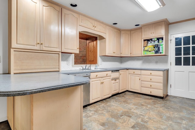 kitchen with light brown cabinetry, sink, stainless steel dishwasher, and kitchen peninsula