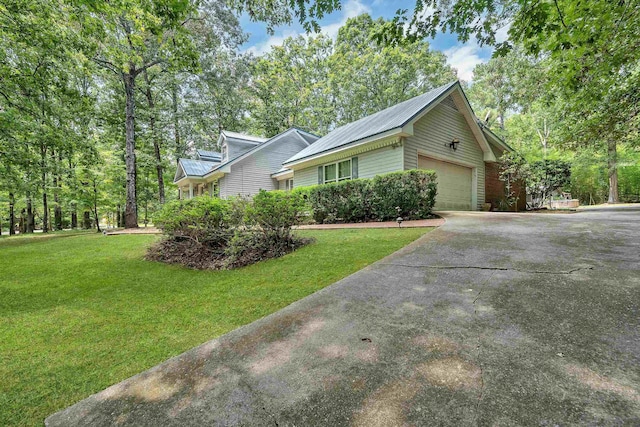 view of side of home featuring a yard and a garage