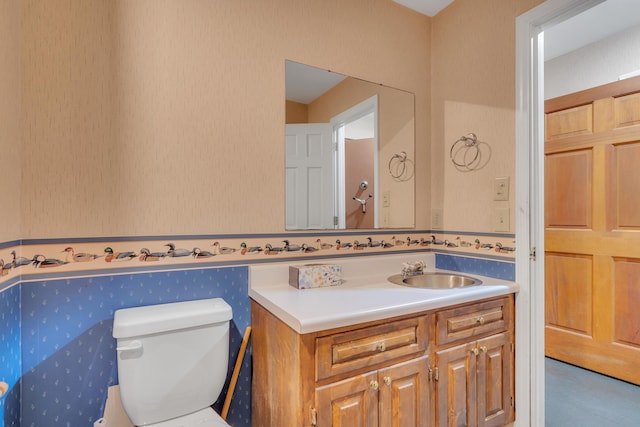 bathroom featuring vanity and toilet