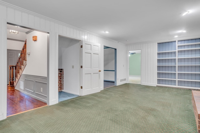 interior space with crown molding and dark carpet