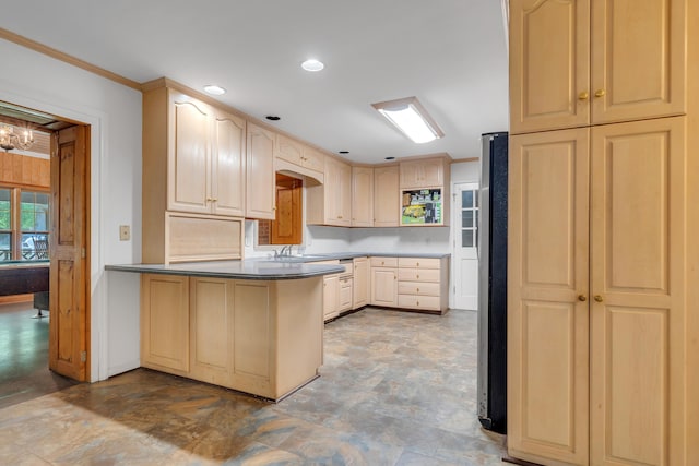 kitchen featuring light brown cabinetry, stainless steel fridge, ornamental molding, kitchen peninsula, and an inviting chandelier