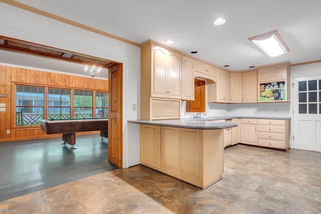 kitchen with ornamental molding, kitchen peninsula, sink, and light brown cabinets