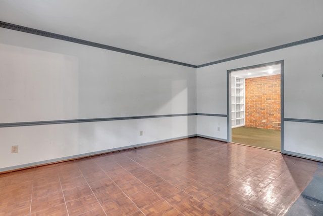 empty room with crown molding and parquet flooring