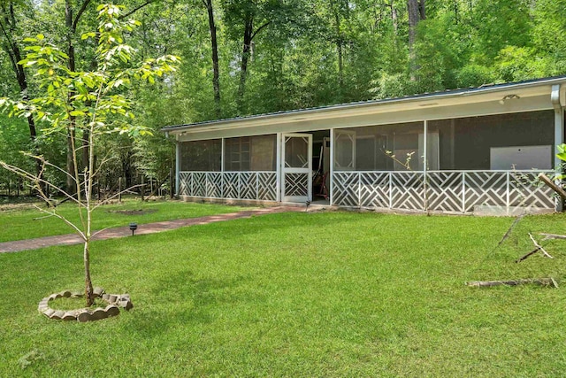 view of front of property with a sunroom and a front lawn