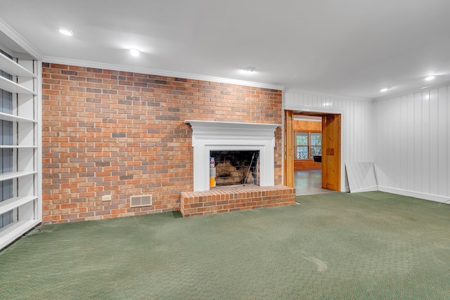 unfurnished living room featuring brick wall, ornamental molding, a brick fireplace, and carpet