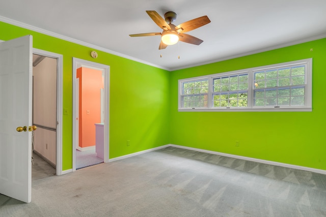 unfurnished bedroom with ornamental molding, light colored carpet, and ceiling fan