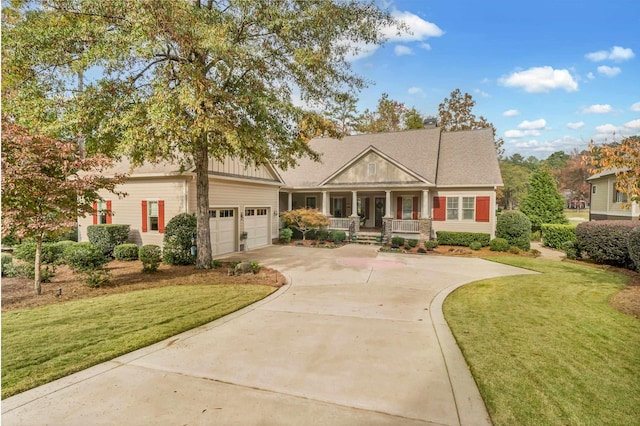 craftsman house with a garage, a front yard, and a porch