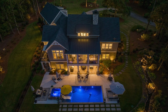 rear view of property featuring a jacuzzi, an outdoor hangout area, a patio, and a balcony
