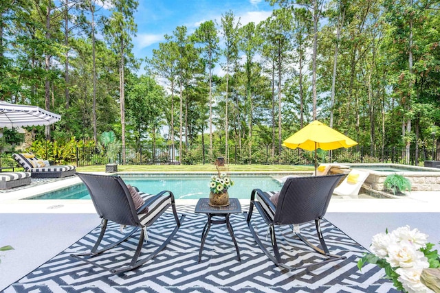 view of pool with an in ground hot tub and a patio area