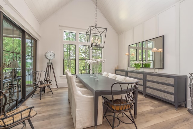 dining room with wood ceiling, light hardwood / wood-style flooring, high vaulted ceiling, and a chandelier