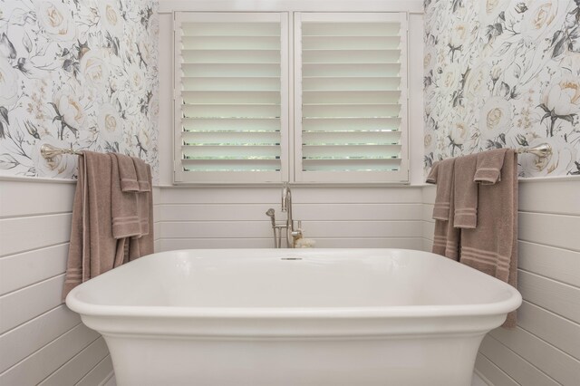 bathroom featuring a healthy amount of sunlight and a washtub