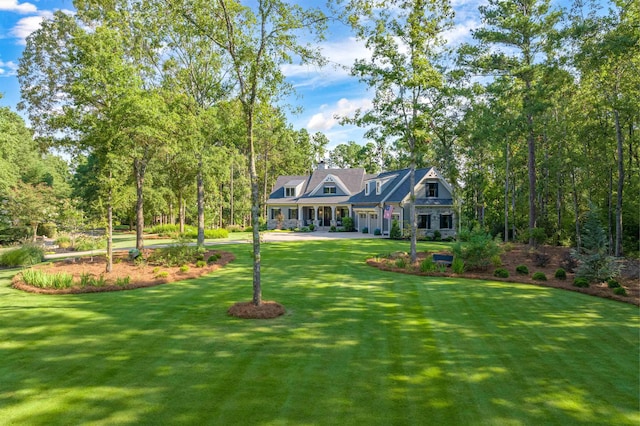 cape cod house with a garage and a front yard