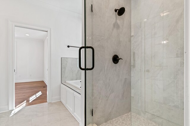 bathroom featuring crown molding and an enclosed shower