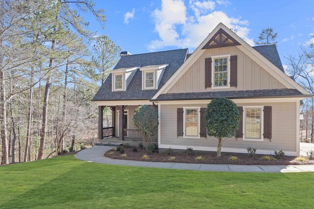 view of front facade featuring covered porch and a front lawn