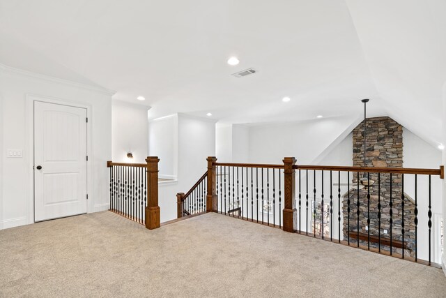 hall with vaulted ceiling and carpet floors