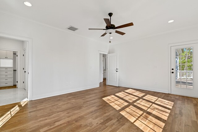 empty room featuring crown molding, hardwood / wood-style floors, and ceiling fan