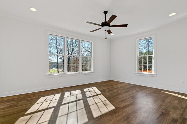 empty room with ornamental molding, dark wood-type flooring, and ceiling fan