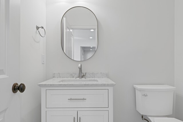 bathroom featuring vanity and toilet