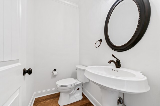 bathroom featuring hardwood / wood-style floors and toilet