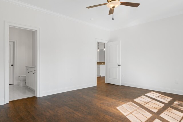 unfurnished bedroom with crown molding, dark hardwood / wood-style floors, ceiling fan, and ensuite bathroom