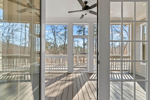 unfurnished sunroom with a wealth of natural light and ceiling fan