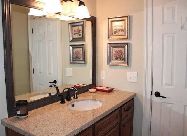 bathroom featuring vanity and a chandelier