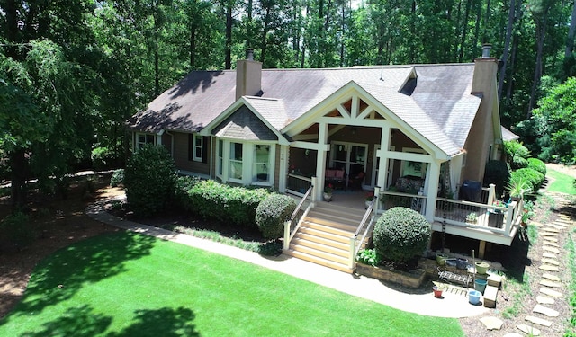 view of front of home featuring a front lawn and a patio