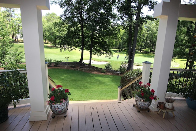 wooden terrace featuring a lawn