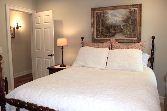 bedroom with dark hardwood / wood-style floors