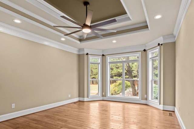 spare room with crown molding, ceiling fan, a raised ceiling, and light hardwood / wood-style flooring