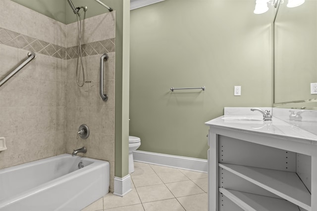 full bathroom featuring tiled shower / bath, vanity, tile patterned floors, and toilet