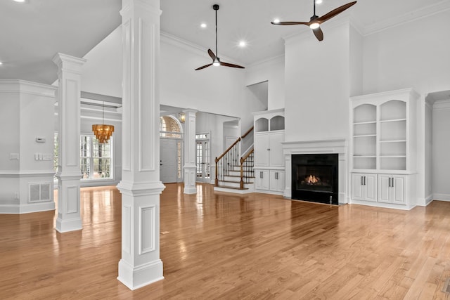 living room with ceiling fan, ornamental molding, decorative columns, and light hardwood / wood-style flooring