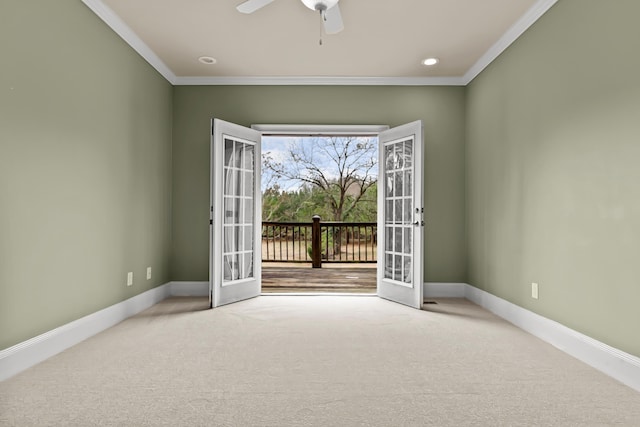 doorway with ceiling fan, light colored carpet, and ornamental molding