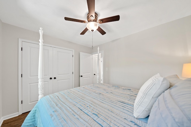 bedroom featuring ceiling fan, a closet, baseboards, and dark wood-style flooring