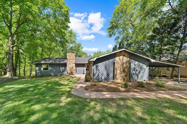 view of front of house with a carport, a front lawn, and a chimney