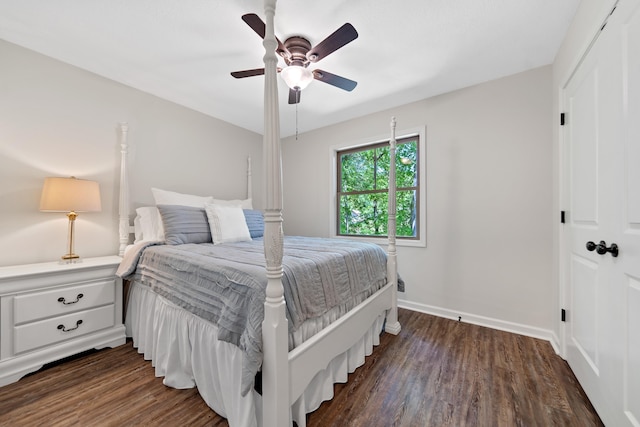 bedroom featuring dark wood finished floors, baseboards, ceiling fan, and a closet