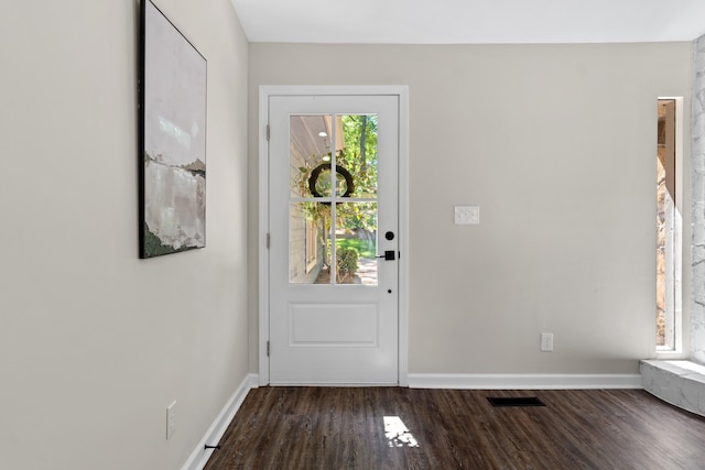 entryway featuring baseboards, dark wood-type flooring, and visible vents
