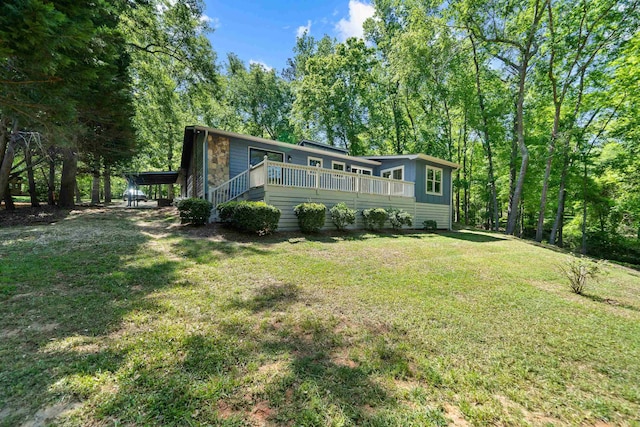 back of property featuring a yard and a deck